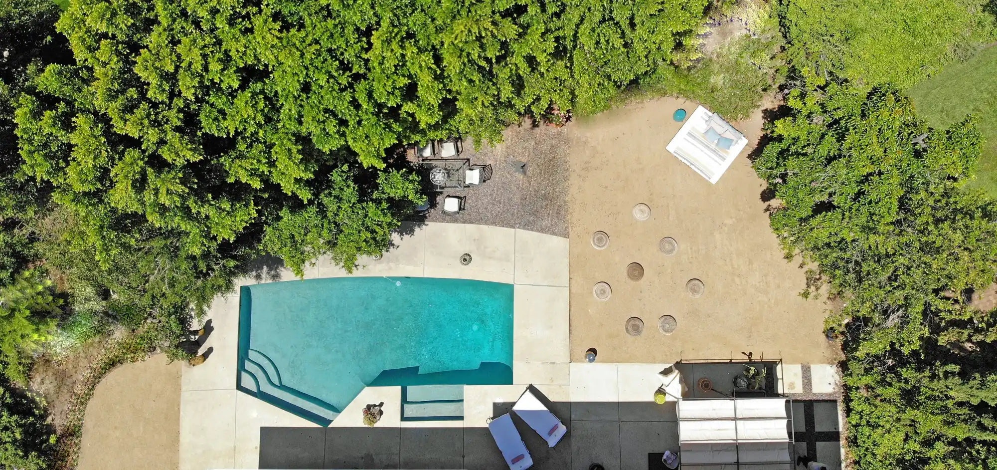 Backyard with pool and landscaping.