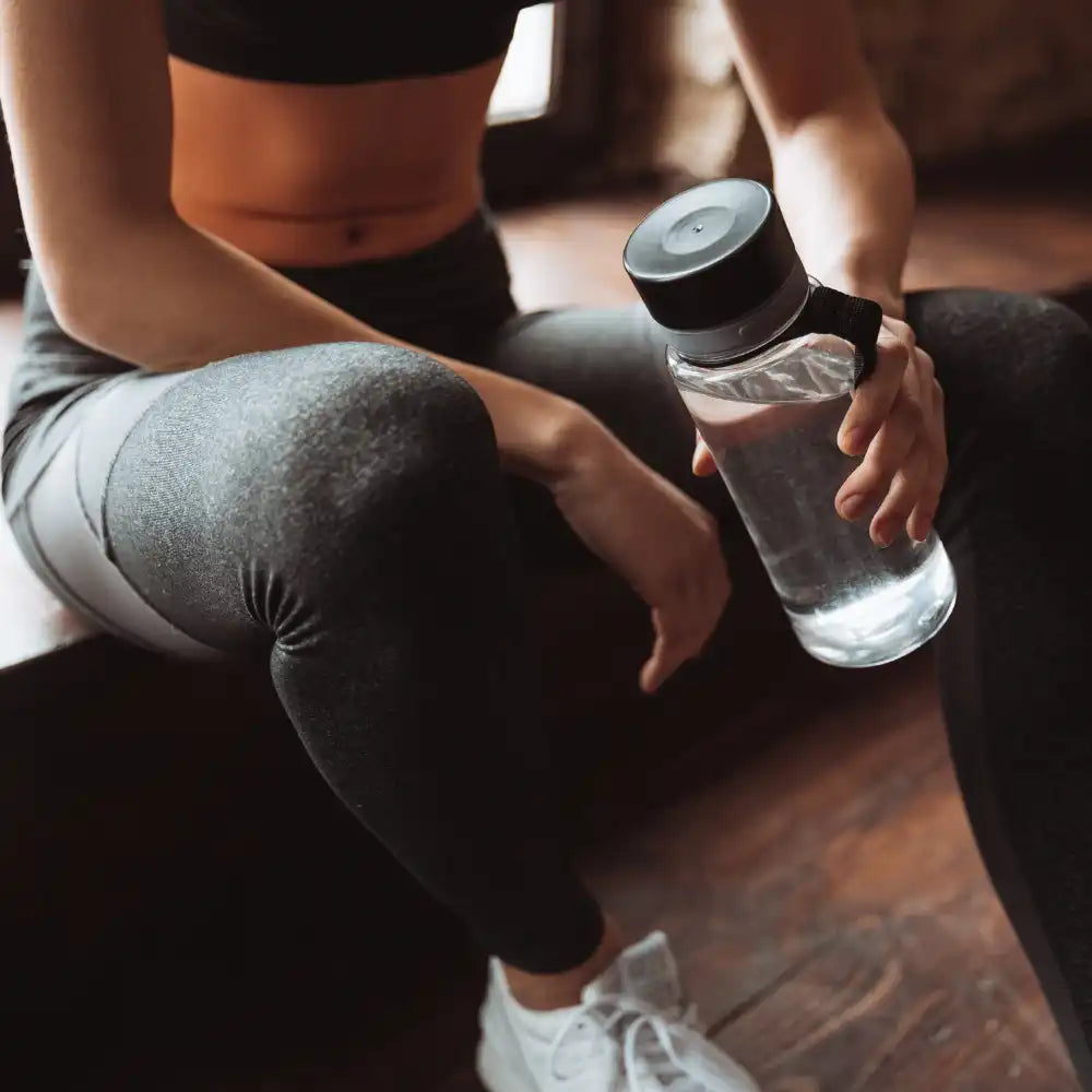 Clear water bottle with black lid.