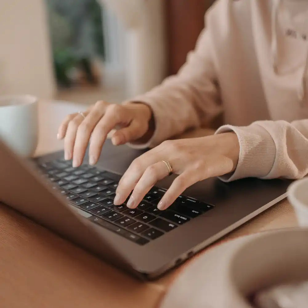 Person typing on a laptop.