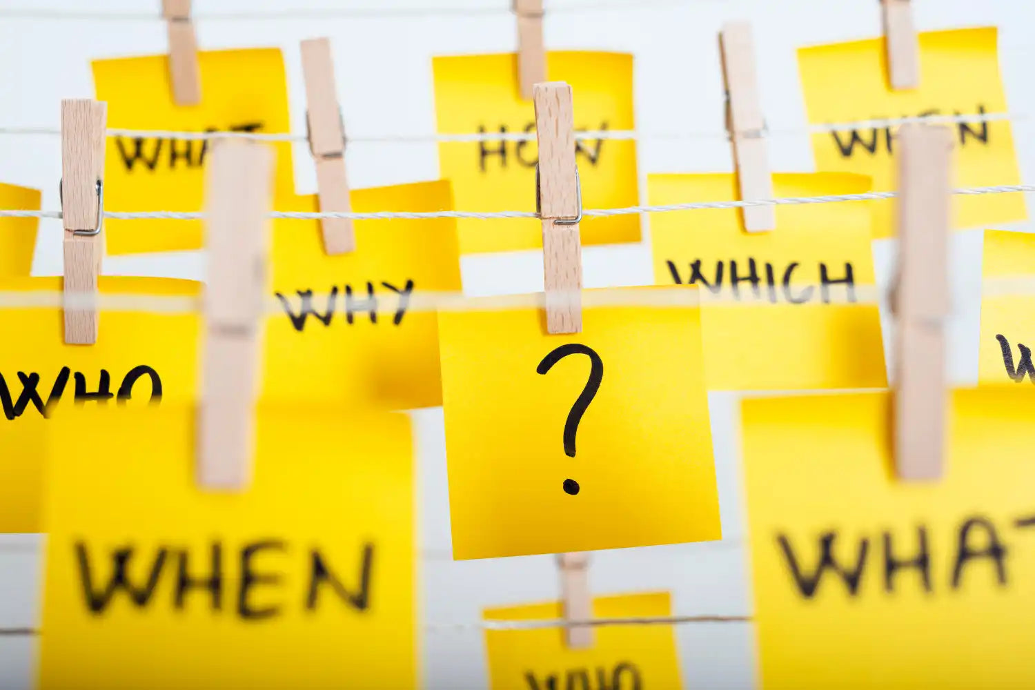 Yellow sticky notes on a clothesline.